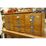 Early 20th century Pine and Beech Bank of Twelve Stationery / Filing / Office Drawers, each with a