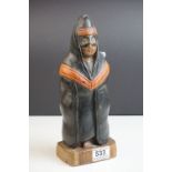 Carved Wooden Figure of a Masked Person wearing a Hooded Cape, possibly South American, 29cms high