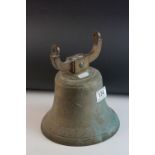 An antique bell missing clanger.