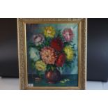 Indistinctly signed still life oil painting of flowers in a vase mounted in a gilt frame