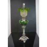 Late 19th century French Oil Lamp, the green glass well raised on a green marble and white metal