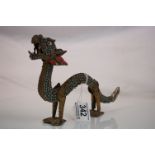 Chinese metal dragon figurine, the body set with Turquoise coloured stones, and red coloured