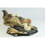 Taxidermy Hen / Chicken with Three Chicks, mounted on a plinth base with sheaths of corn, 33cms long