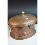 Large Copper Oval Casket, the hinged lid with brass knop finial, the body with brass ring handles,