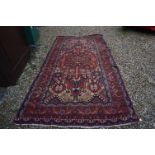Eastern Wool Red Ground Rug with stylised pattern, 330cms x 170cms