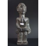 Hardwood Carved Tribal Figure of a Man holding a Club, 28cms high