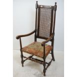 Early 20th century Oak Elbow Chair with bergere panel to back and needlework covered seat, 121cms