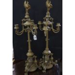 Pair of Brass Aesthetic Movement Three Branch Candelabra with Bird Finials, raised on three legs