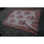 Red Ground Rug with a floral pattern, 270cms x 190cms