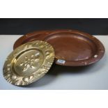 Two arts and crafts Lombard copper chargers and a similar brass plate with stylized heart and