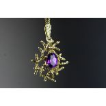 9ct Gold Pendant, the central claw set oval cut amethyst within an openwork design of entwining