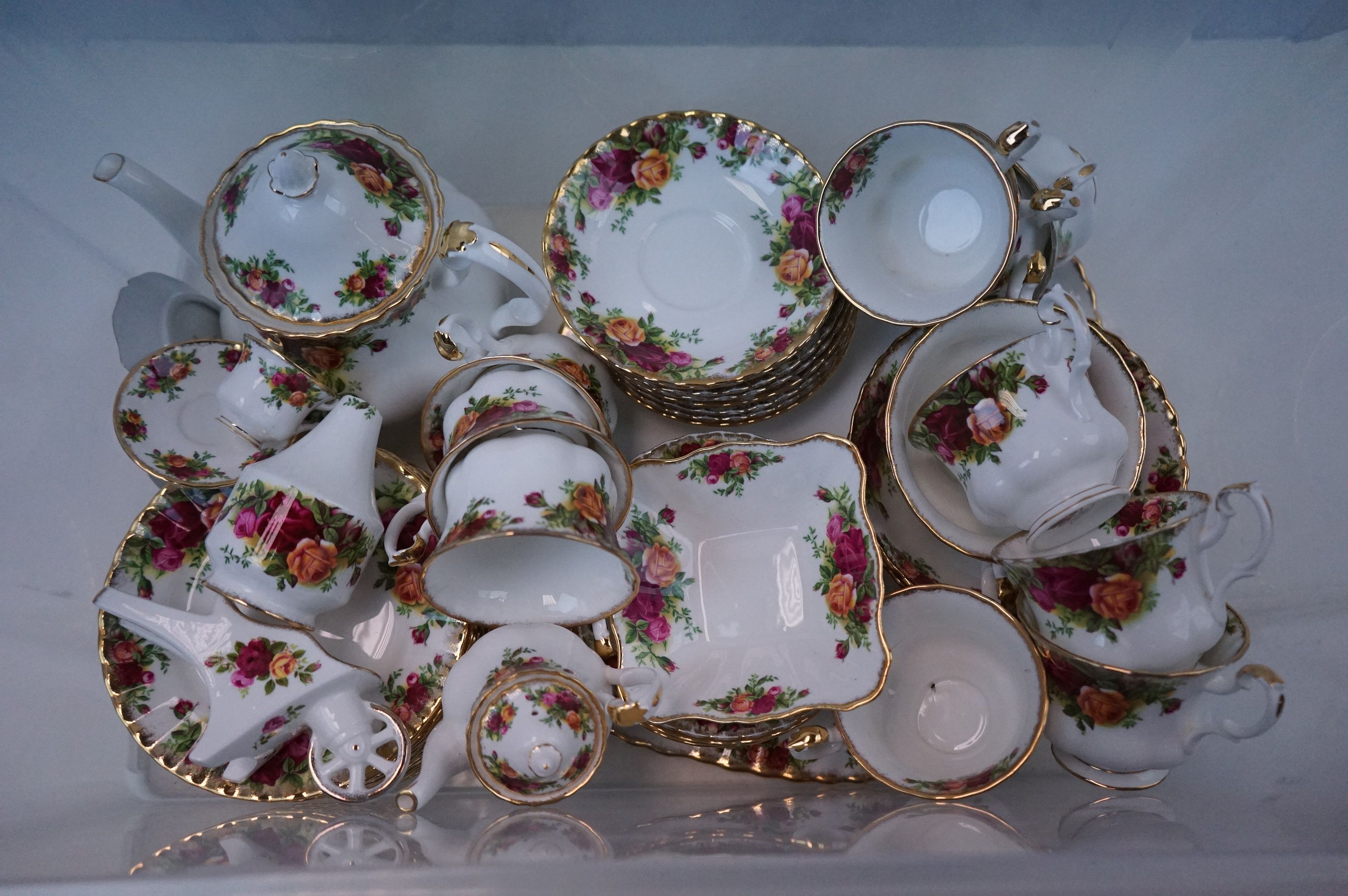 A Royal Albert Country Roses part tea set to include cups and saucers teapot bowl etc.