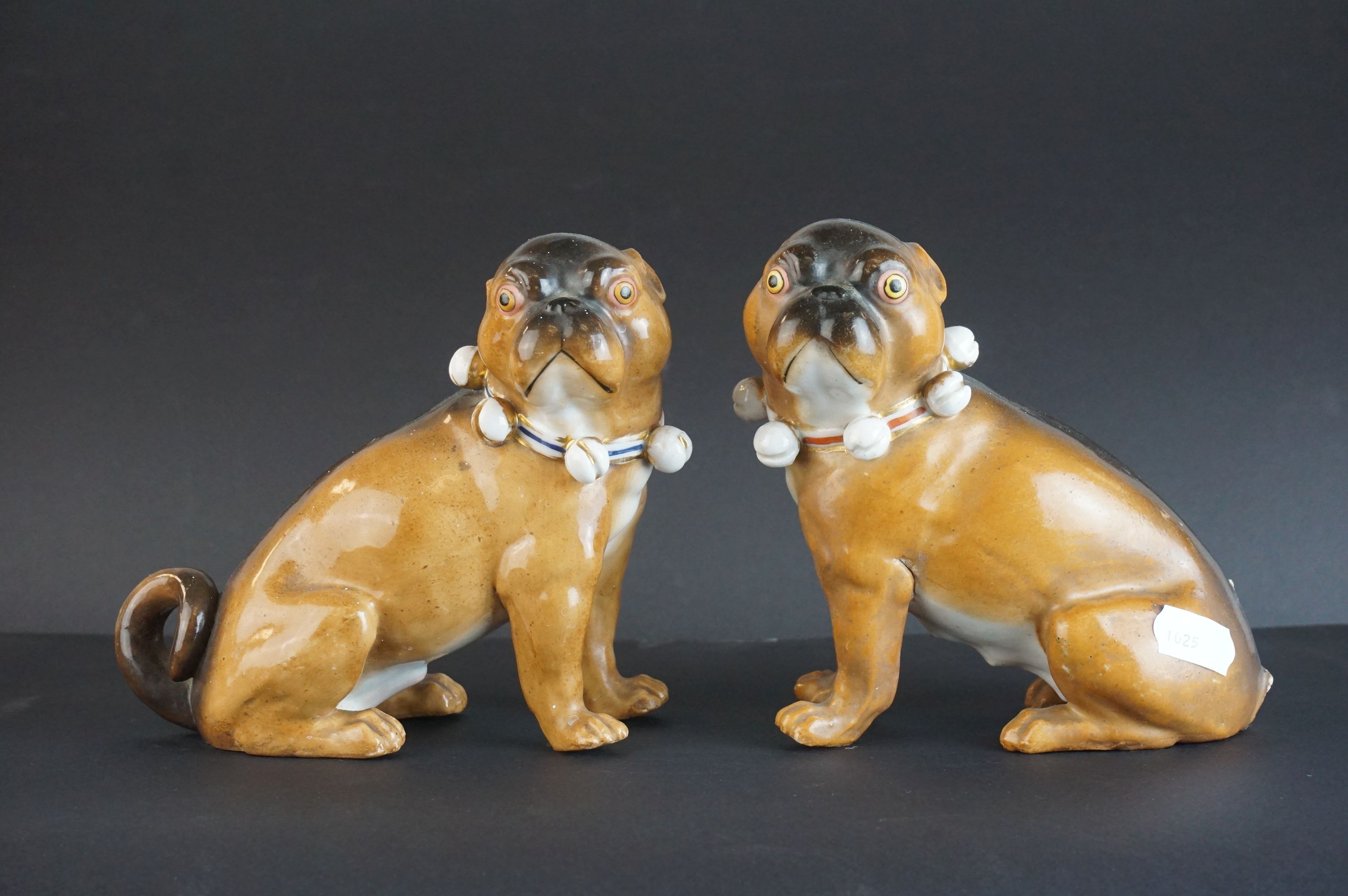 Pair of 19th century Meissen Style Porcelain Seated Pugs with bell collars, 13cms high (one with