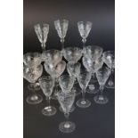 Part suite of seventeen port and wine glasses, the trumpet bowls engraved with foliate decoration (
