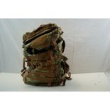 A Military camouflage rucksack together with helmets a water bottle and an Avon gas mask purportedly