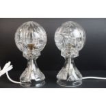 A pair of cut glass deco style lamps with wheel cut decoration.