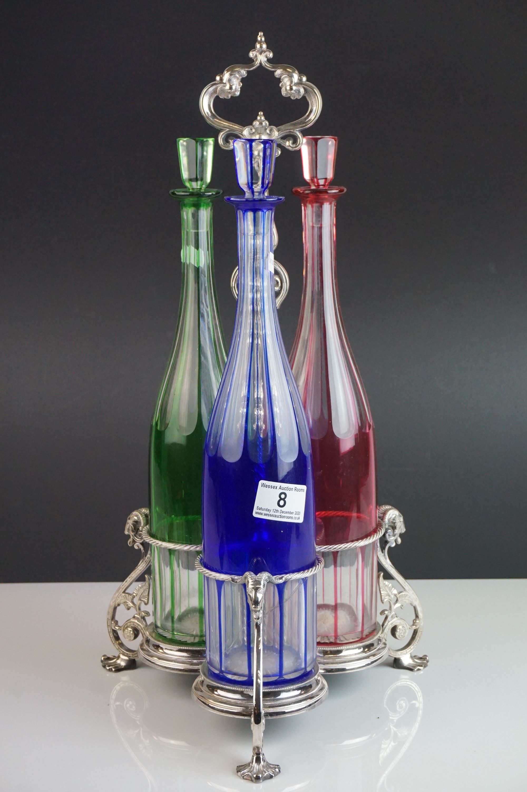 Set of Three Bohemian Coloured Glass Tall Decanters with Stoppers (blue, green and red) held on a