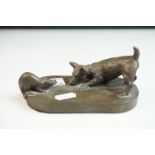 A bronzed resin sculpture of a Terrier dog with rat signed Juliet.