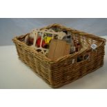 A quantity of dolls house furniture in a wicker basket.
