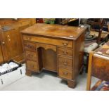 George III Style Mahogany Kneehole Desk, an arrangement of seven drawers together with a sliding