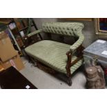 Late Victorian / Edwardian Salon Settee, the curved back with button upholstery, raised on turned