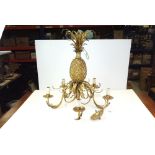 A gilt five branch candelabra with pineapple decoration.