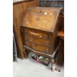 Early 20th century Walnut Bureau, the serpentine front with three drawers, raised on cabriole