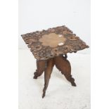 Kashmir Square Table, profusely carved with foliage and fauna, raised on a folding base, 46cms