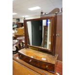 Early 19th century Mahogany Swing Dressing Mirror, with brass finials, raised on a bow fronted