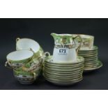 A Noritake green ground tea set, painted with raised gilt designs, comprising ten tea cups and
