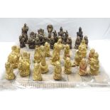 A ceramic painted chess set in the form of mythical figures and creatures.