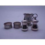 Pair of silver h/m cruets, 2 x silver napkin rings, and a silver Christening jug with inscription,