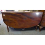 Cuban mahogany oval topped gate leg dining table with 2 drop sides, turned supports with brass