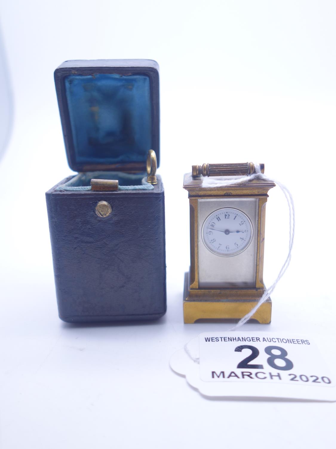 Good quality Fine Miniature travel clock, in original blue leather case, the miniature bronze