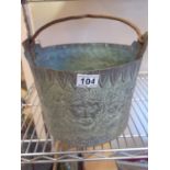 Antique metalware Bucket decorated with embossed decoration of flowers, serpents, and mans head,