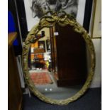 Early 19 th Century oval over mantle mirror, with scrolling style gilt decoration, needs restoration