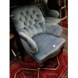 Blue upholstered open Gentleman's armchair with button backed decoration serpentine fronted on