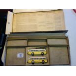 Trolley Bus HO with original box, in tatty condition, enclosed are 2 tin plate trams, yellow colour,