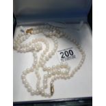 Cultured Pearl necklace, double strung with 9ct gold claps and a sliver and gilt pendant centre,