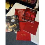13 x Vintage Cartier magazine or programmes and 1 copy of Cologni made by Cartier hard backed book