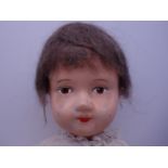 Edwardian or Victorian doll, with natural hair and later painted face, cloth body and head, 14" tall