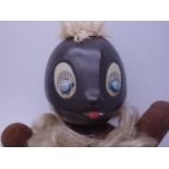 Unusual 1920's caricature doll, with black stylized head and painted eyelashes, with cloth hands,