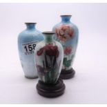 3 x assorted early 20th century Cloisonné vases decorated with flowers on hard wood bases, 1 pair