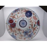 Large Oriental blue and white charger, decorated with hand painted enamels to the front, Imari