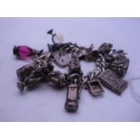 Silver charm bracelet set with numerous charms 124 grams total est 50-80