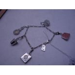 Silver charm bracelet set with numerous charms,
