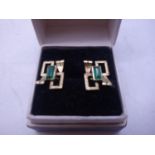 Pair of un-marked 14ct GOLD and emerald stud earrings, stylized design with emerald set to each