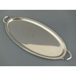 A silver drinks tray with twin handles, Sheffield 1918, Atkin Bros., oval with a plain border,