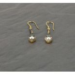 A pair of drop earrings  set with emeralds and pearls