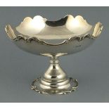 A silver comport, London 1903, circular with a foliate cast ogee rim, raised on a similar circular